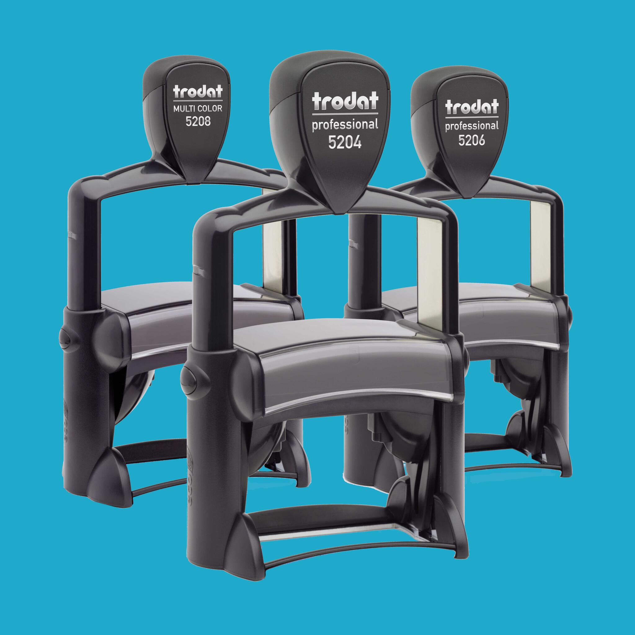 Round self-inking stamp on top of white paper with a black ink impression