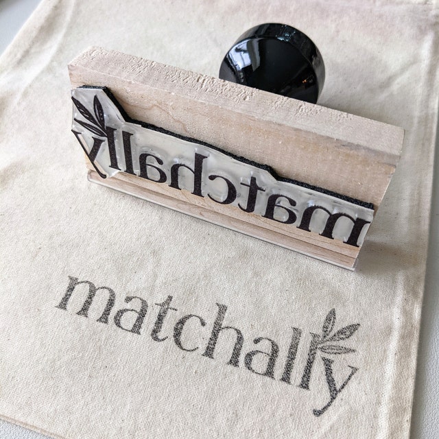 2x4 Wood Handle Rubber Stamp on canvas with black stamped impression of