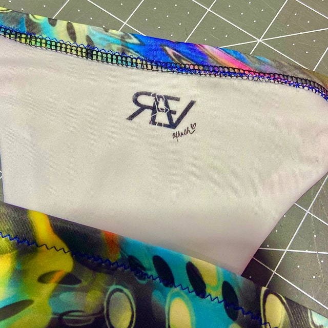 picture of inside of bathing suit with black fabric stamp impression