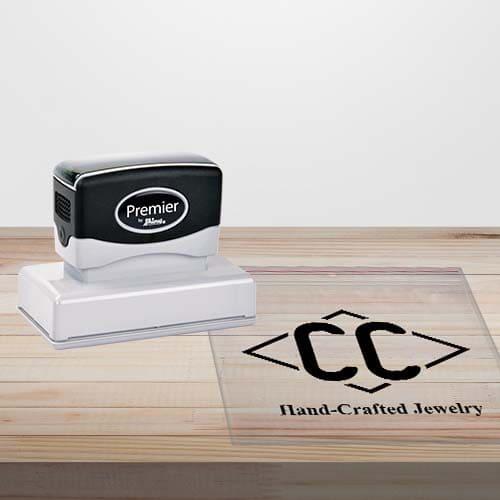picture of a multi-surface pre-inked stamp with black ink impression on a clear plastic bag 