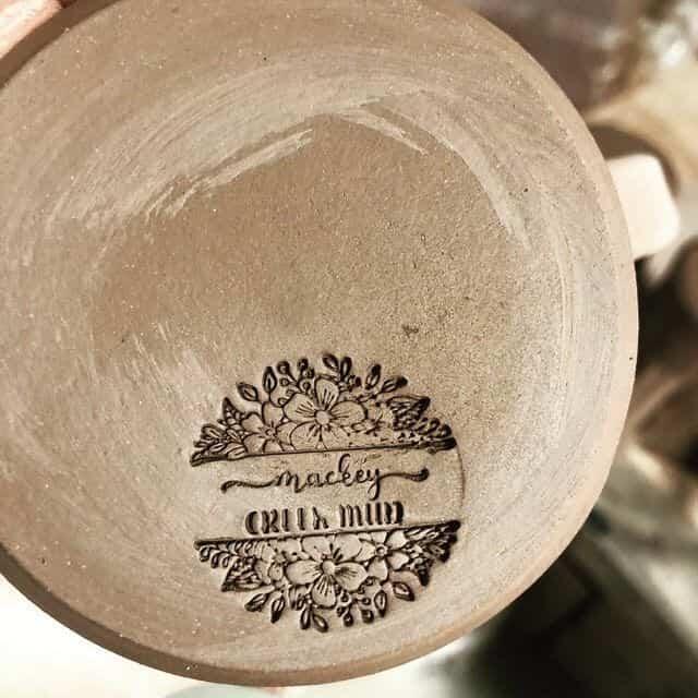 intricate, round, floral impression in bottom of clay pottery